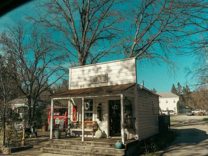 Small white general store with a porch in a rural Arkansas town